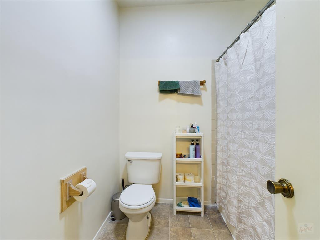 2313 Longview Street, Unit 102 Austin, TX 78705 - Photo 9 of 14 a bathroom with a toilet sink and mirror