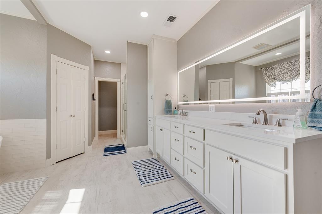 669 VZ County Road Canton, TX 75103 - Photo 23 of 40 Recently remodeled beautiful primary bath. Oversized cabinets with granite countertops, double sinks, long lighted mirror, his and hers walk in closets.