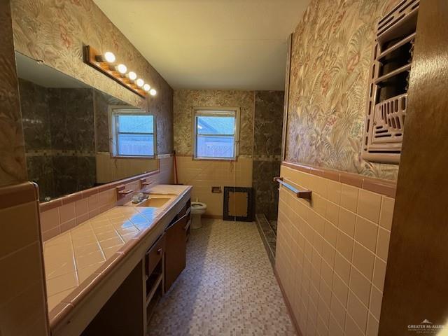 1606 North Grant Street Roma, TX 78584 - Photo 6 of 16 a bathroom with a double vanity sink a mirror and a bathtub