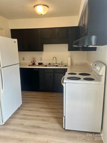 a kitchen with stainless steel appliances a stove a sink and a refrigerator
