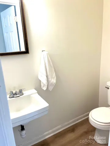 a bathroom with a sink a toilet and mirror