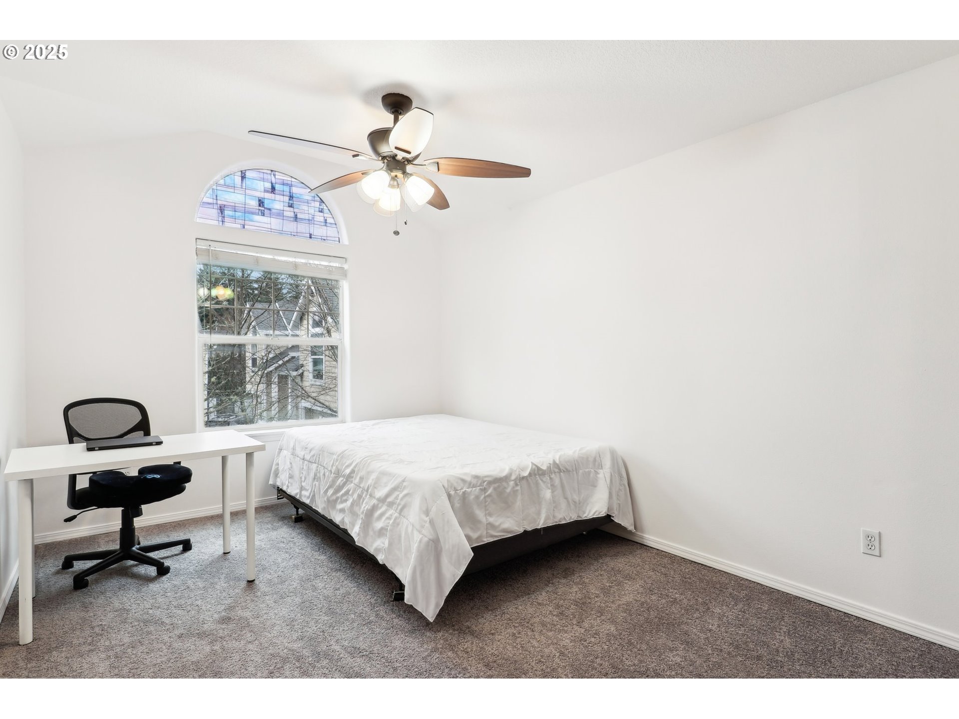 19153 Southeast Yamhill Street, Unit 21 Portland, OR 97233 - Photo 12 of 22 a bedroom with a bed a desk and chair