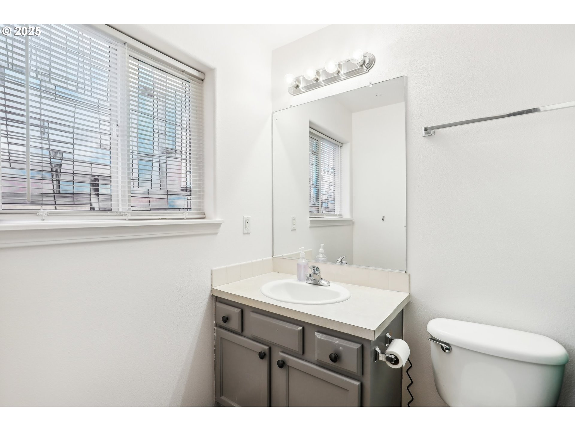 19153 Southeast Yamhill Street, Unit 21 Portland, OR 97233 - Photo 16 of 22 a bathroom with a sink mirror and a toilet