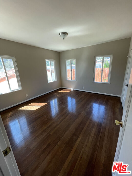 23 Melrose Avenue Pasadena, CA 91105 - Photo 11 of 15 wooden floor in an empty room with a window