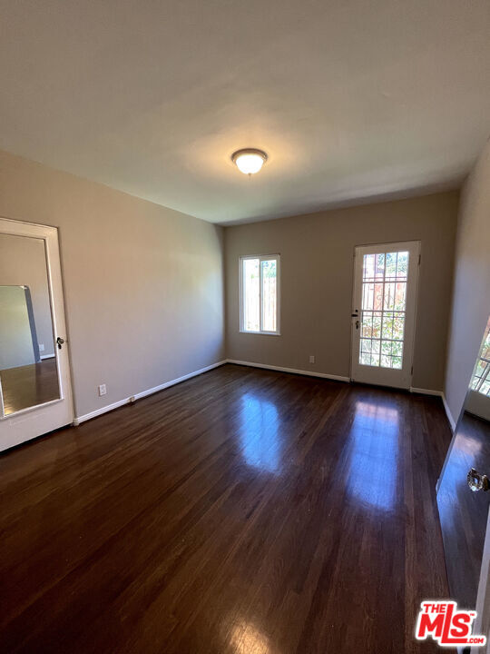 23 Melrose Avenue Pasadena, CA 91105 - Photo 12 of 15 a view of an empty room with wooden floor and fan