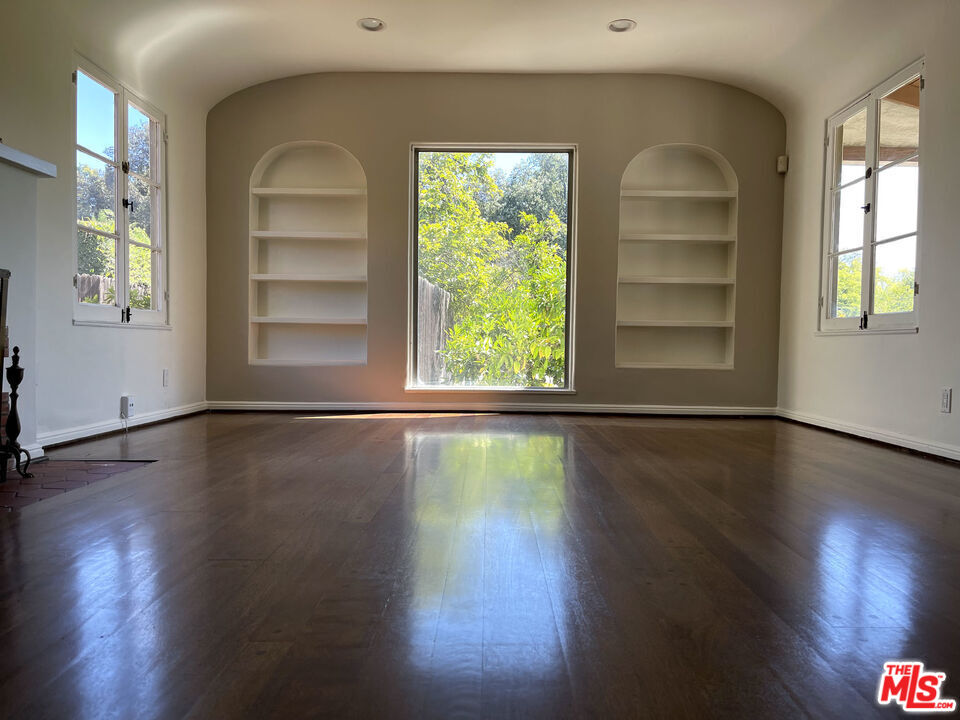 23 Melrose Avenue Pasadena, CA 91105 - Photo 3 of 15 a view of an empty room with wooden floor and a window