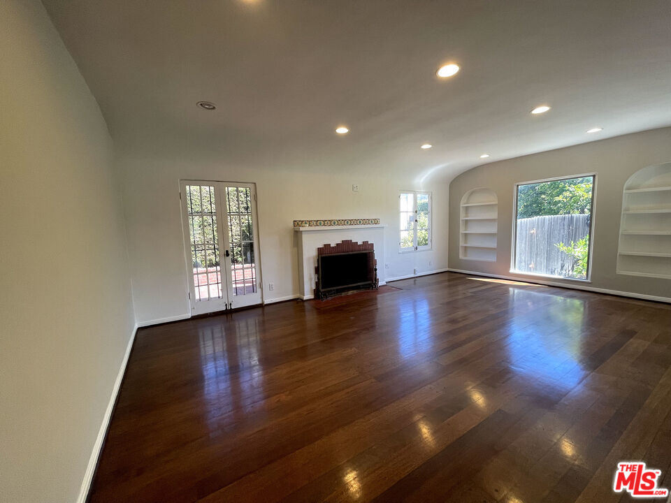 23 Melrose Avenue Pasadena, CA 91105 - Photo 4 of 15 an empty room with wooden floor and windows