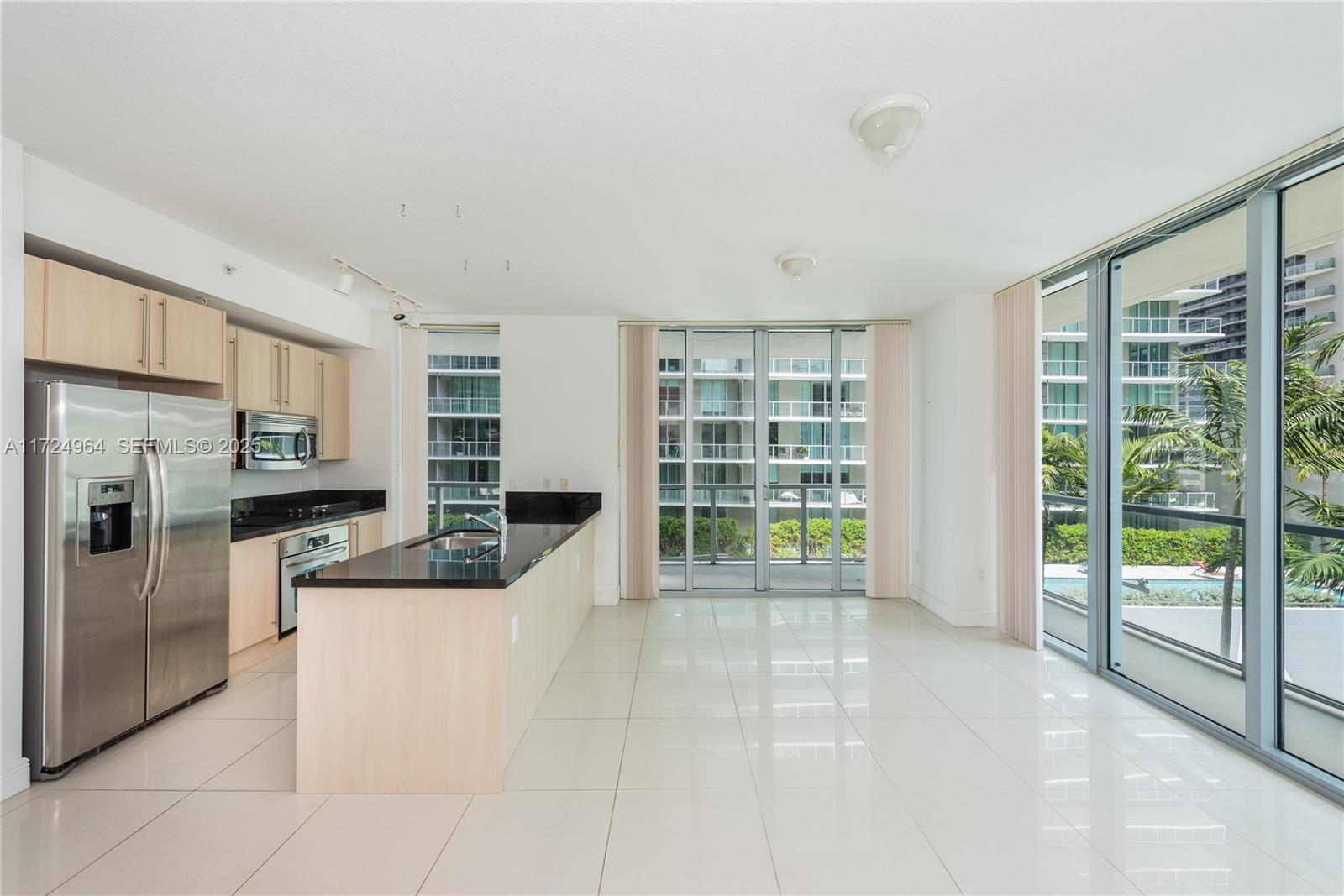 79 Southwest 12th Street, Unit 1107S Miami, FL 33130 - Photo 2 of 26 a living room with stainless steel appliances furniture and a kitchen view