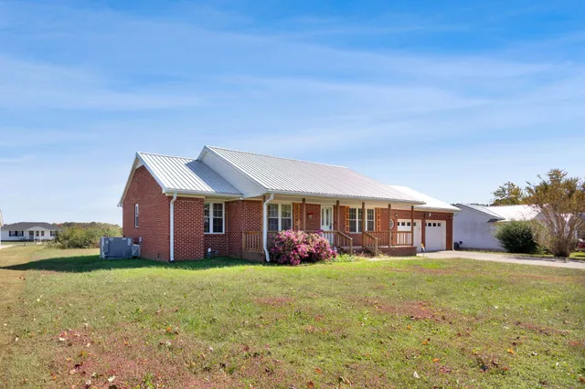 a front view of house with yard and green space