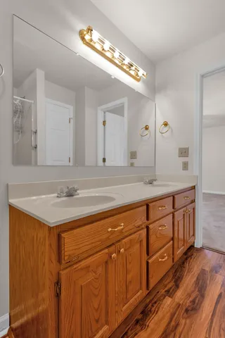 a bathroom with a sink double vanity and a mirror