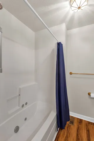 a bathroom with a bathtub and a shower