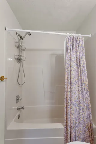 a bathroom with a shower and a bath tub