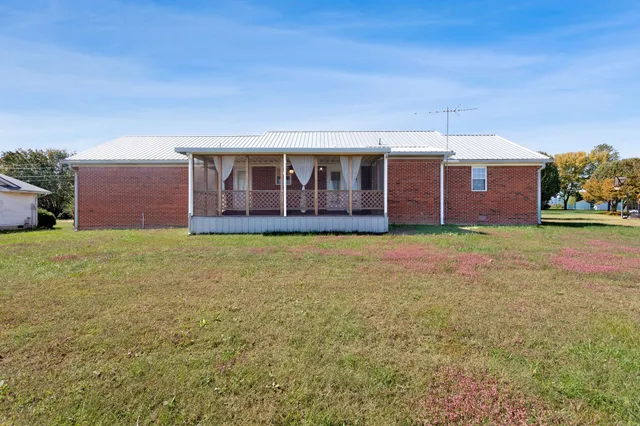 a view of a house with a yard and garage