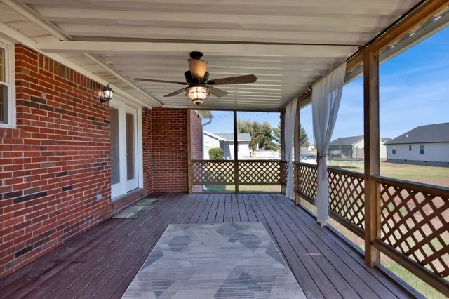 a view of a porch with wooden floor