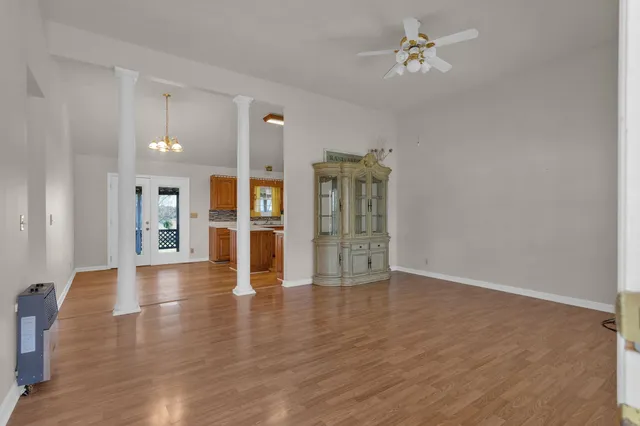 wooden floor in an empty room with a window