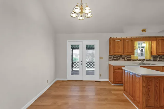 wooden floor with chandelier and sink