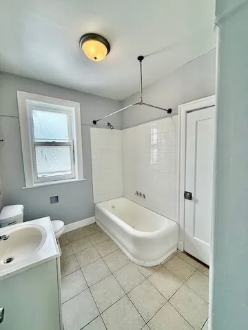 a spacious bathroom with a bathtub and a shower