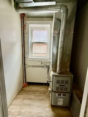 a view of a hall with floor to ceiling window and a ceiling fan