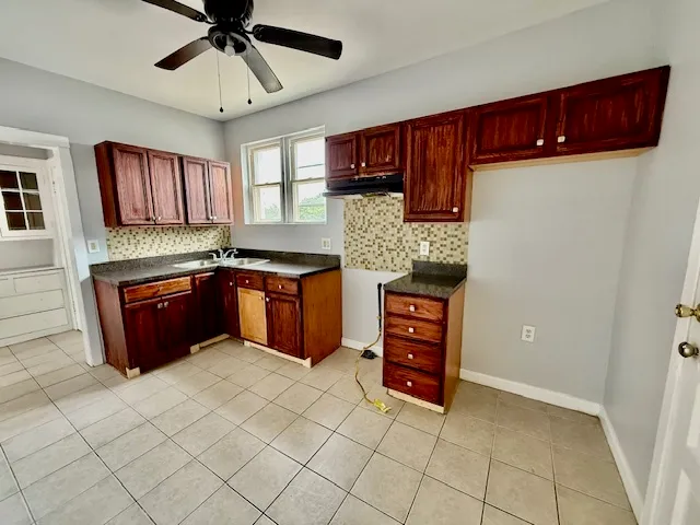 a kitchen with stainless steel appliances granite countertop a stove and a refrigerator