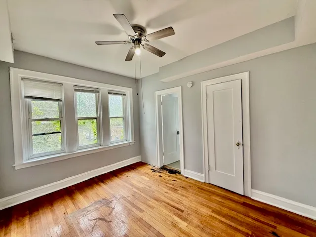 a view of a livingroom with a window and wooden floor