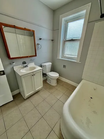a bathroom with a sink mirror and toilet