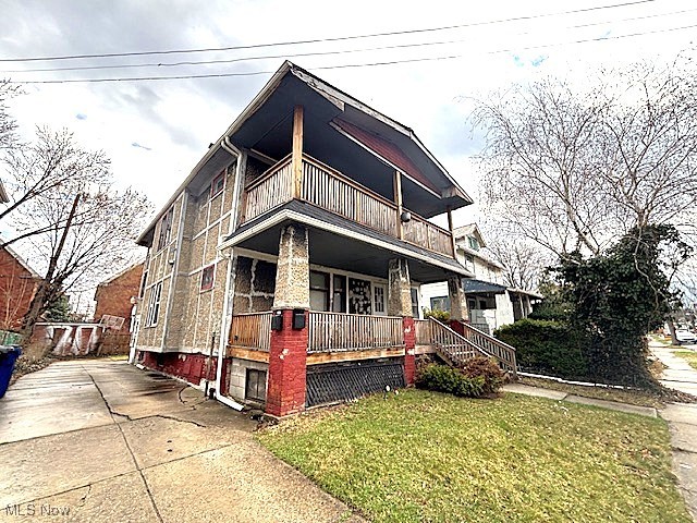 805 Rudyard Road Cleveland, OH 44110 - Photo 3 of 45 View of front of home with a balcony, a porch, and a front lawn
