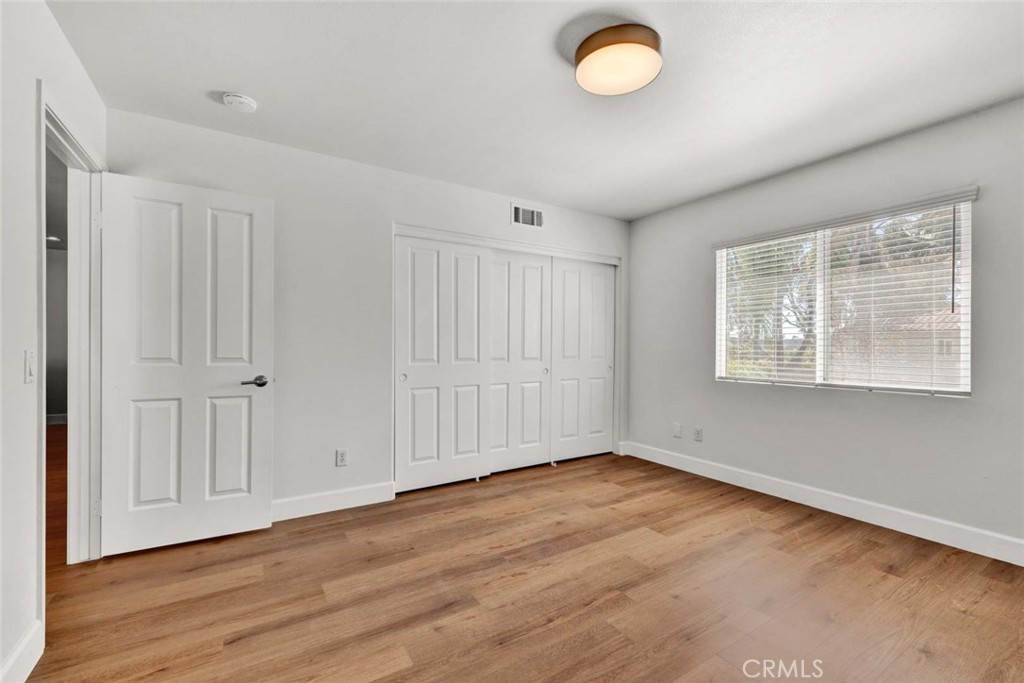 24 Pheasant Creek Irvine, CA 92618 - Photo 16 of 43 an empty room with wooden floor and windows
