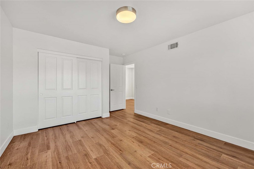 24 Pheasant Creek Irvine, CA 92618 - Photo 17 of 43 a view of an empty room with wooden floor and fan