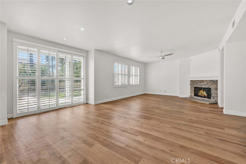 24 Pheasant Creek Irvine, CA 92618 - Photo 22 of 43 an empty room with wooden floor and fireplace