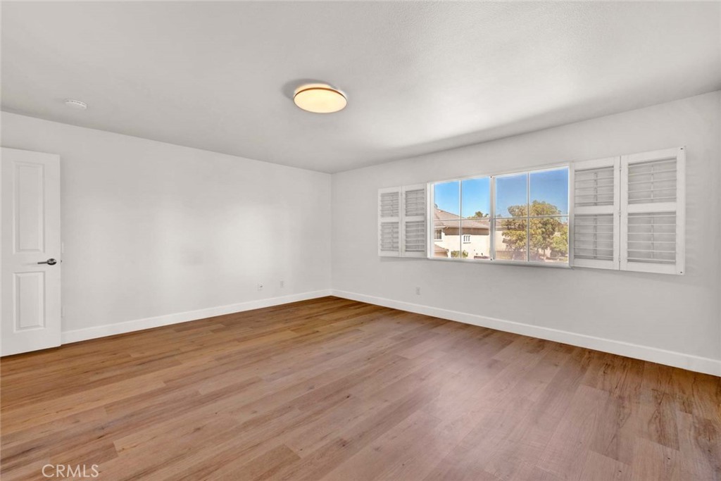 24 Pheasant Creek Irvine, CA 92618 - Photo 23 of 43 an empty room with wooden floor and windows