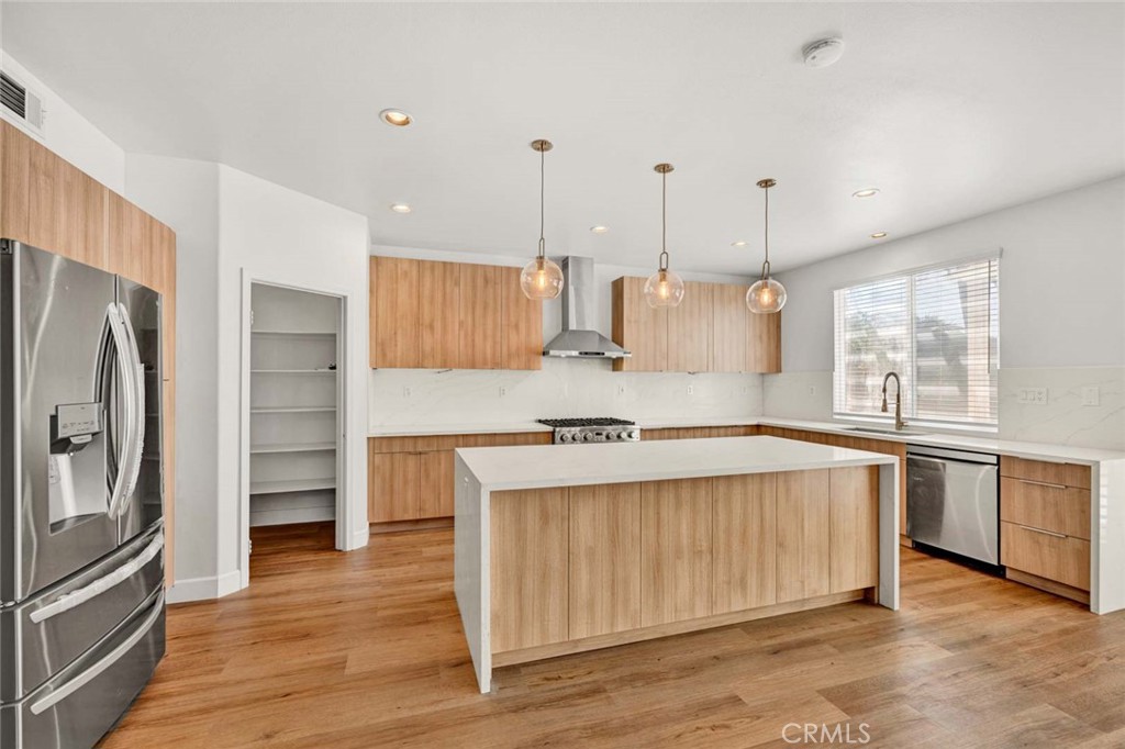 24 Pheasant Creek Irvine, CA 92618 - Photo 5 of 43 a kitchen with stainless steel appliances granite countertop a sink a stove and a refrigerator