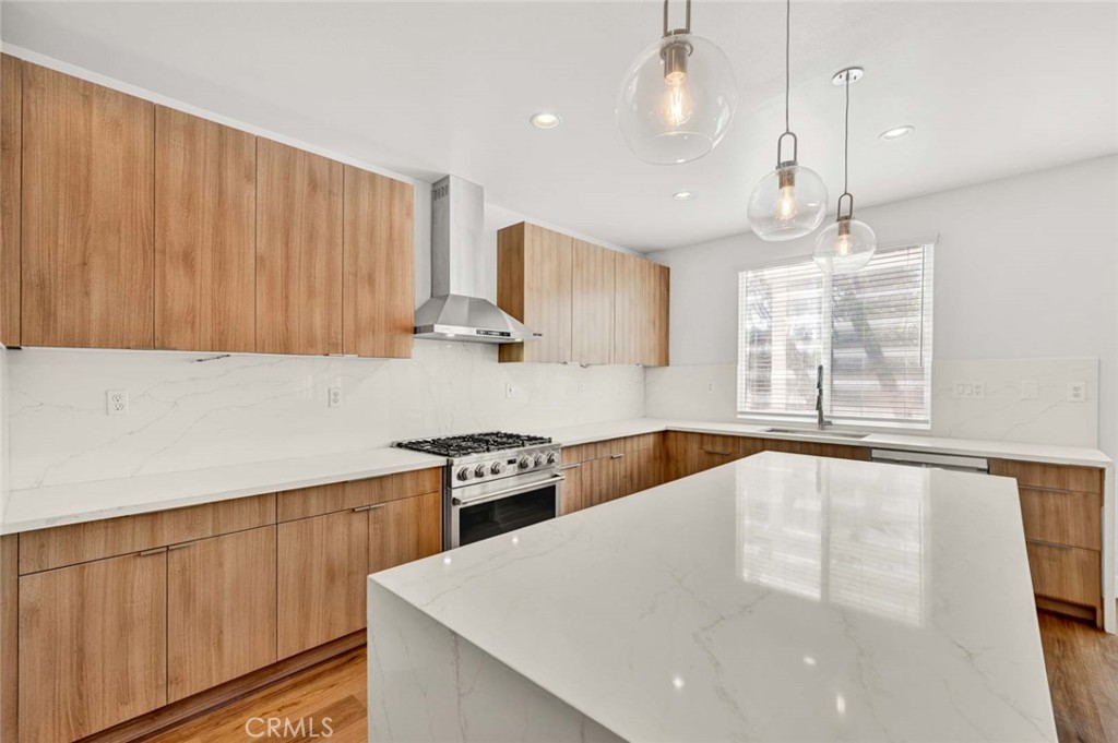 24 Pheasant Creek Irvine, CA 92618 - Photo 6 of 43 a kitchen with stainless steel appliances a stove sink and cabinets