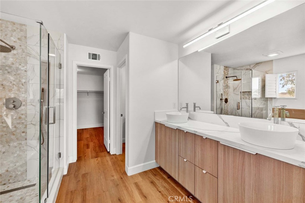 24 Pheasant Creek Irvine, CA 92618 - Photo 10 of 43 a bathroom with a double vanity sink mirror and shower