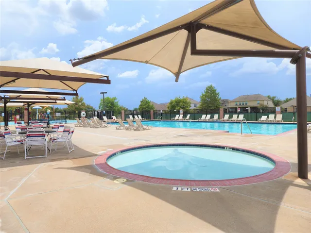 swimming pool view with a lake view