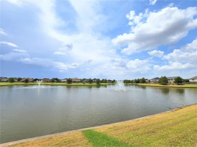 a view of a lake with houses in the back