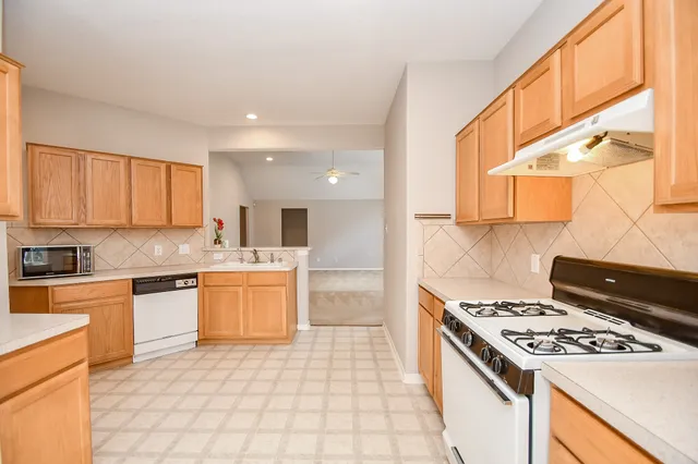 a kitchen with a sink and a refrigerator