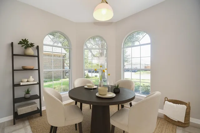 an empty room with windows and mirror