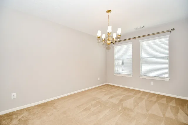 a spacious bedroom with a large bed couch and a window
