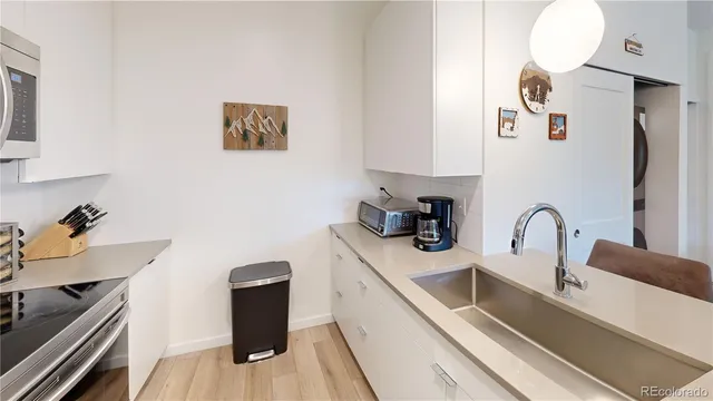 a bedroom with a large bed and a painting on the wall