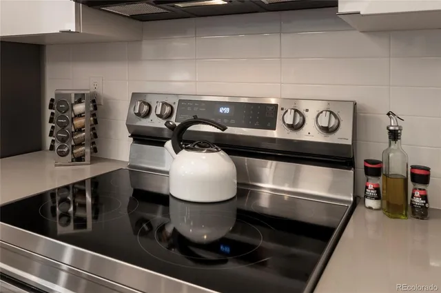 a bedroom with a bed and a lamp on dresser