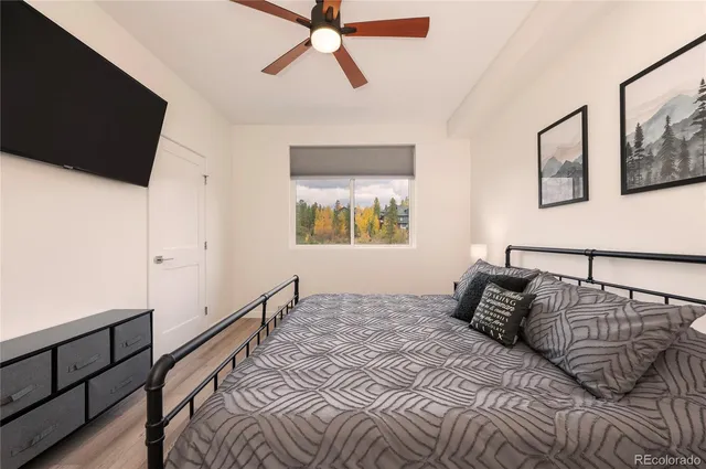 a view of a city from a balcony with furniture