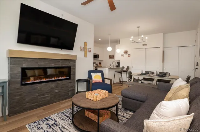 a living room with furniture and a painting on the wall