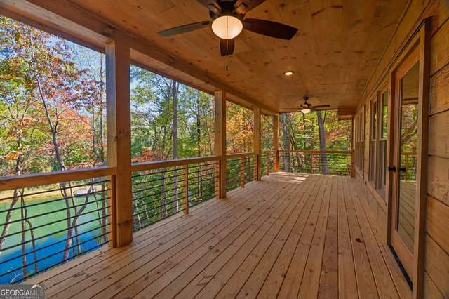 a view of balcony with wooden floor and fence