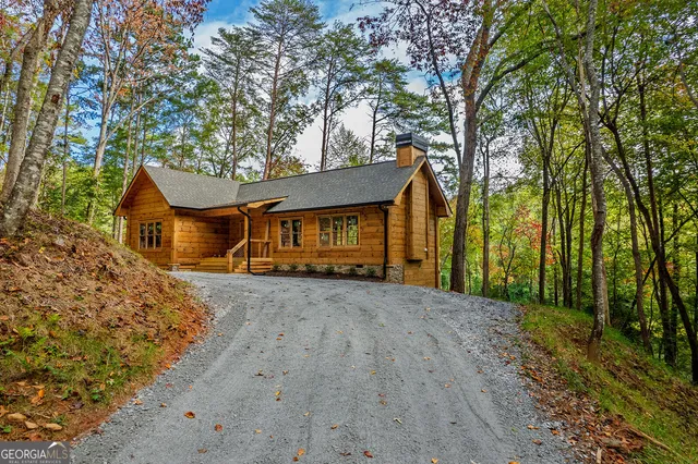 a backyard of a house with barbeque oven and door