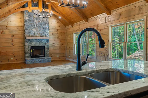 a kitchen with sink a stove and cabinets