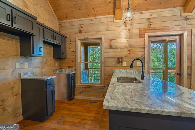 a kitchen with sink a stove and cabinets