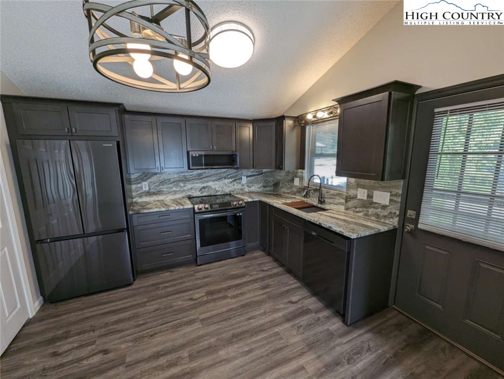 25 Meadow Loop Newland, NC 28657 - Photo 14 of 35 a kitchen with stainless steel appliances granite countertop a sink stove and refrigerator