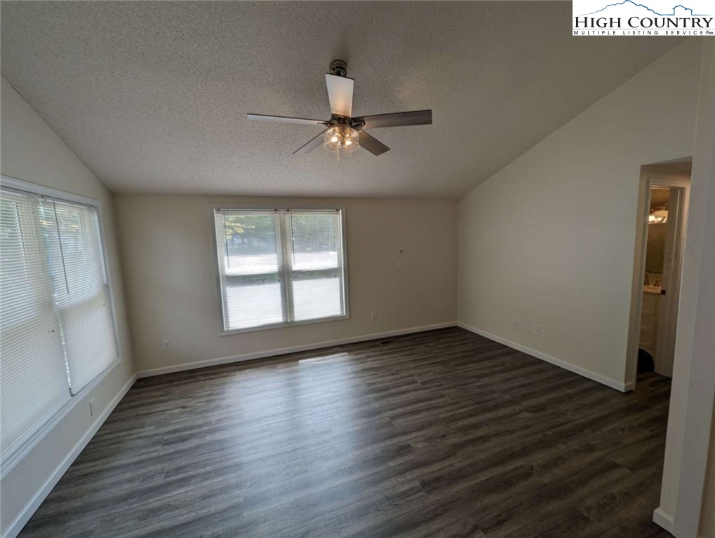 25 Meadow Loop Newland, NC 28657 - Photo 20 of 35 an empty room with wooden floor fan and windows