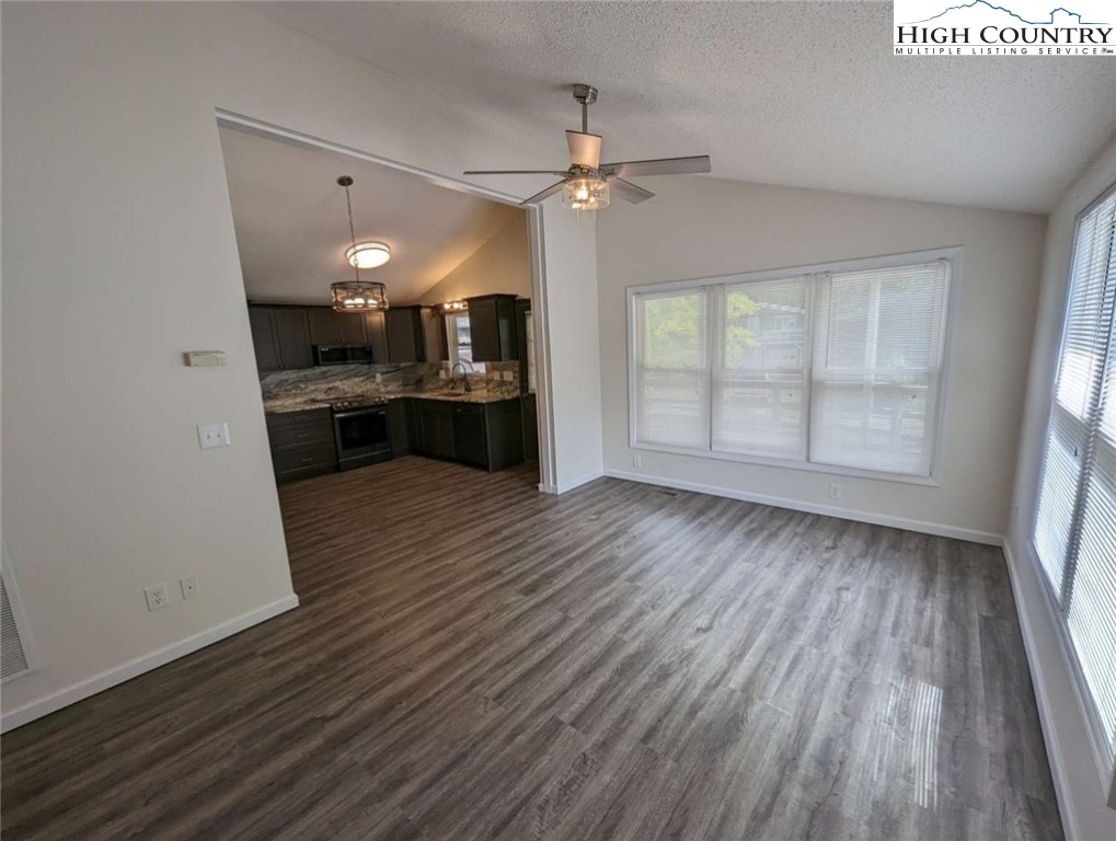 25 Meadow Loop Newland, NC 28657 - Photo 22 of 35 wooden floor in an empty room with a kitchen