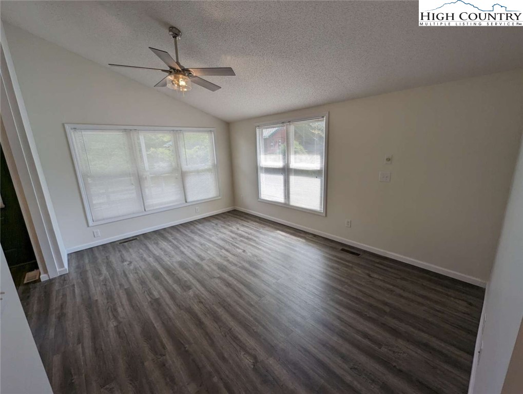 25 Meadow Loop Newland, NC 28657 - Photo 23 of 35 an empty room with wooden floor fan and windows